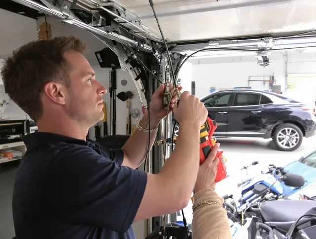 Hinesville Garage Door Repair safety certified technician performing cable replacement in Hinesville